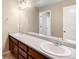 Large bathroom features dual sinks, warm cabinetry, and well lit vanity at 1339 Sidewinder Cir, Castle Rock, CO 80108
