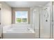 Clean bathroom features soaking tub, separate shower, and bright window at 1339 Sidewinder Cir, Castle Rock, CO 80108