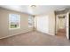 Neutral bedroom featuring carpet, a double window with blinds, and a large sliding door closet at 1339 Sidewinder Cir, Castle Rock, CO 80108