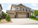 Inviting two-story home with a spacious three-car garage and a beautifully landscaped front yard at 1339 Sidewinder Cir, Castle Rock, CO 80108