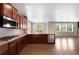 Modern kitchen boasts dark wood cabinets, granite countertops, stainless steel appliances, and hardwood floors at 1339 Sidewinder Cir, Castle Rock, CO 80108