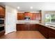 Well-appointed kitchen featuring dark wood cabinetry, granite countertops, and stainless steel appliances at 1339 Sidewinder Cir, Castle Rock, CO 80108