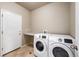 Well-lit laundry room features side-by-side washer and dryer and ample countertop space at 1339 Sidewinder Cir, Castle Rock, CO 80108