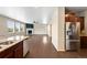 Bright living area with a fireplace, large windows, hardwood floors, and a stainless steel refrigerator at 1339 Sidewinder Cir, Castle Rock, CO 80108