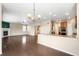 Spacious living area seamlessly connecting the kitchen, dining, and living spaces with hardwood floors at 1339 Sidewinder Cir, Castle Rock, CO 80108
