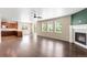 Bright, open-concept living area with a fireplace, hardwood floors, and an adjacent kitchen space at 1339 Sidewinder Cir, Castle Rock, CO 80108