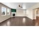 Comfortable living room with hardwood floors, a ceiling fan, a cozy fireplace, and ample natural light at 1339 Sidewinder Cir, Castle Rock, CO 80108