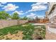Expansive backyard featuring a stone wall, trampoline, and a patio for relaxation at 24356 E Powers Ave, Aurora, CO 80016