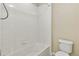 Bathroom featuring a bathtub with shower and a toilet in a neutral color palette at 24356 E Powers Ave, Aurora, CO 80016