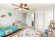 bedroom featuring two twin beds, ceiling fan, and play kitchen at 24356 E Powers Ave, Aurora, CO 80016