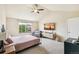 Cozy bedroom with a large window, neutral carpet, and a ceiling fan at 24356 E Powers Ave, Aurora, CO 80016