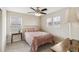Bedroom features a bed, lamp, and windows with natural light at 24356 E Powers Ave, Aurora, CO 80016