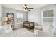 Comfortable Bedroom features a crib, chair, and bookshelf near a bright window at 24356 E Powers Ave, Aurora, CO 80016