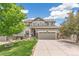 Inviting two-story home with a well-manicured lawn and a spacious two-car garage at 24356 E Powers Ave, Aurora, CO 80016