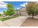 Inviting two-story home with a well-manicured lawn and a spacious two-car garage at 24356 E Powers Ave, Aurora, CO 80016