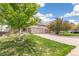 Charming two-story home featuring a well-maintained front yard with lush landscaping and a stone facade at 24356 E Powers Ave, Aurora, CO 80016