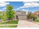 Inviting two-story home with a well-manicured lawn and a spacious two-car garage at 24356 E Powers Ave, Aurora, CO 80016