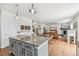 Open concept living area with a fireplace, hardwood floors, and adjoining kitchen at 24356 E Powers Ave, Aurora, CO 80016