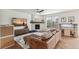 Cozy living room with stone fireplace, hardwood floors, and comfortable seating area at 24356 E Powers Ave, Aurora, CO 80016