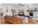 Cozy living room with fireplace, ceiling fan, wood floors, and exposed brick at 24356 E Powers Ave, Aurora, CO 80016