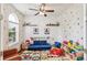 Playroom with bright, natural light, rainbow rug, and ample storage at 24356 E Powers Ave, Aurora, CO 80016