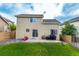 A home featuring a backyard with green grass and a patio, perfect for outdoor entertaining at 5972 S Zante Way, Aurora, CO 80015