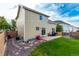 The spacious backyard features a patio, lush lawn, and tasteful landscaping at 5972 S Zante Way, Aurora, CO 80015