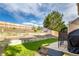 A backyard boasting a well-maintained lawn, tiered landscaping, and a patio perfect for outdoor enjoyment at 5972 S Zante Way, Aurora, CO 80015