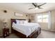 Serene bedroom featuring a ceiling fan, cozy bedding, and a large window with natural light at 5972 S Zante Way, Aurora, CO 80015