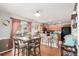 Bright dining area with wood floors, a table with four chairs, and access to outdoor space at 5972 S Zante Way, Aurora, CO 80015