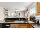 Open kitchen view with a stainless steel sink, granite counters, and breakfast bar at 5972 S Zante Way, Aurora, CO 80015