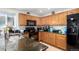 Well-equipped kitchen featuring granite counters, stainless steel sink, and ample cabinetry at 5972 S Zante Way, Aurora, CO 80015