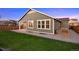 Back exterior featuring the patio, lawn, and garden plot at 10049 Isle St, Parker, CO 80134