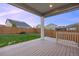 Back patio area with wooden deck and fenced in yard at dusk at 10049 Isle St, Parker, CO 80134