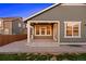 Back of home with patio, lawn and outdoor covered living area at 10049 Isle St, Parker, CO 80134