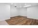 Finished basement with hard wood flooring, bright lighting, and white walls at 10049 Isle St, Parker, CO 80134