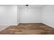 Basement area with wood floors, pendant lighting and bright white walls at 10049 Isle St, Parker, CO 80134
