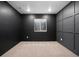 Modern bedroom featuring dark walls, a window with blinds and trim details at 10049 Isle St, Parker, CO 80134