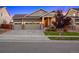 Traditional home with a three-car garage, well-manicured lawn, and mature trees at 10049 Isle St, Parker, CO 80134