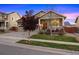 Front exterior view of a house with a porch, manicured lawn, and trees at 10049 Isle St, Parker, CO 80134