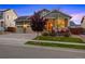 Inviting single-story home with a cozy front porch and a meticulously maintained yard at 10049 Isle St, Parker, CO 80134