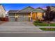 Charming single-story home boasts a well-manicured lawn and a welcoming front porch at 10049 Isle St, Parker, CO 80134