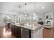 Open kitchen with a large center island, stainless appliances, and a view to the living area at 10049 Isle St, Parker, CO 80134