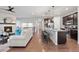 Open concept kitchen and living area with pendant lighting and stainless steel appliances at 10049 Isle St, Parker, CO 80134