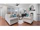 Bright living room features large windows, hardwood floors, and a cozy fireplace at 10049 Isle St, Parker, CO 80134