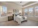 Bright bedroom has a tray ceiling, carpeted floors, and large windows with backyard views at 10049 Isle St, Parker, CO 80134
