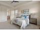 Bright and airy bedroom has a tray ceiling, ceiling fan, and ensuite bath with a soaking tub at 10049 Isle St, Parker, CO 80134