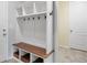 Mudroom with a custom built-in storage bench, coat hooks, shelves, and base storage for shoes and other items at 10049 Isle St, Parker, CO 80134