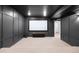 Modern theater room with a screen and neutral carpeted floors at 10049 Isle St, Parker, CO 80134