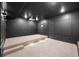Home theater with a projector, platform seating, and modern wall paneling at 10049 Isle St, Parker, CO 80134